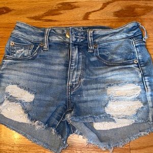 Ripped jean shorts with lace pockets